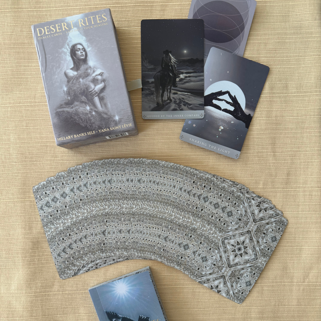 Desert Rites Oracle complete set with guidebook and 44 full-color desert themed cards displayed in fan showing gold edges and desert-themed illustrations.