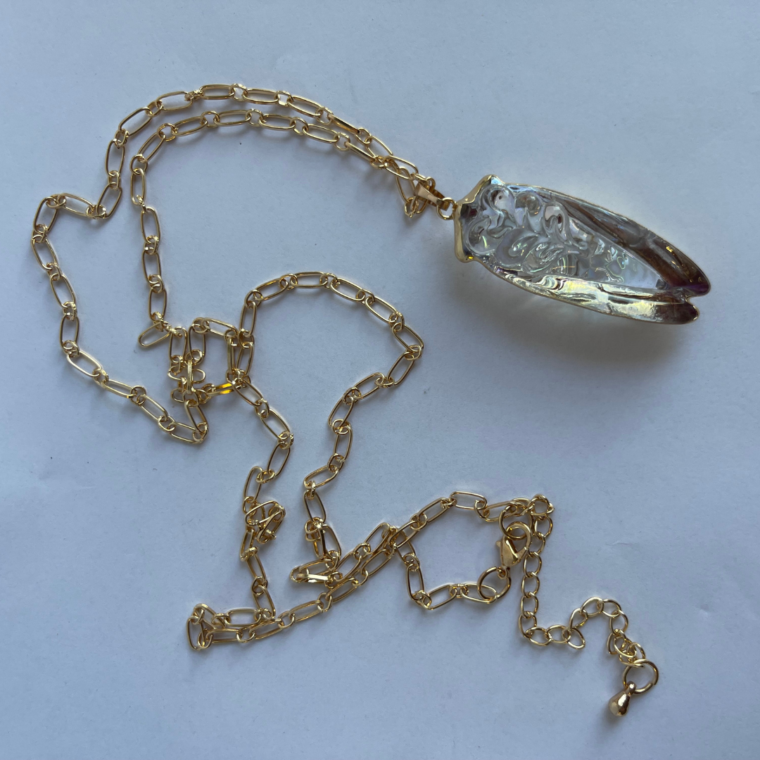 Underside view of iridescent glass cicada necklace showing pendant size and chain length